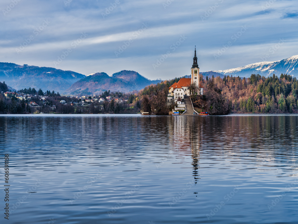 Lake Bled island church front strair and bled village during a cloudy winter afternoon, Bled, Slovenia