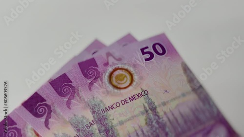 Billetes nuevos de 50 pesos mexicanos sobre una mesa blanca. Mexican money. photo