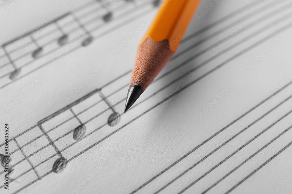 Sheet with musical notes and pencil, closeup view Sheet with musical notes and pencil, closeup view
