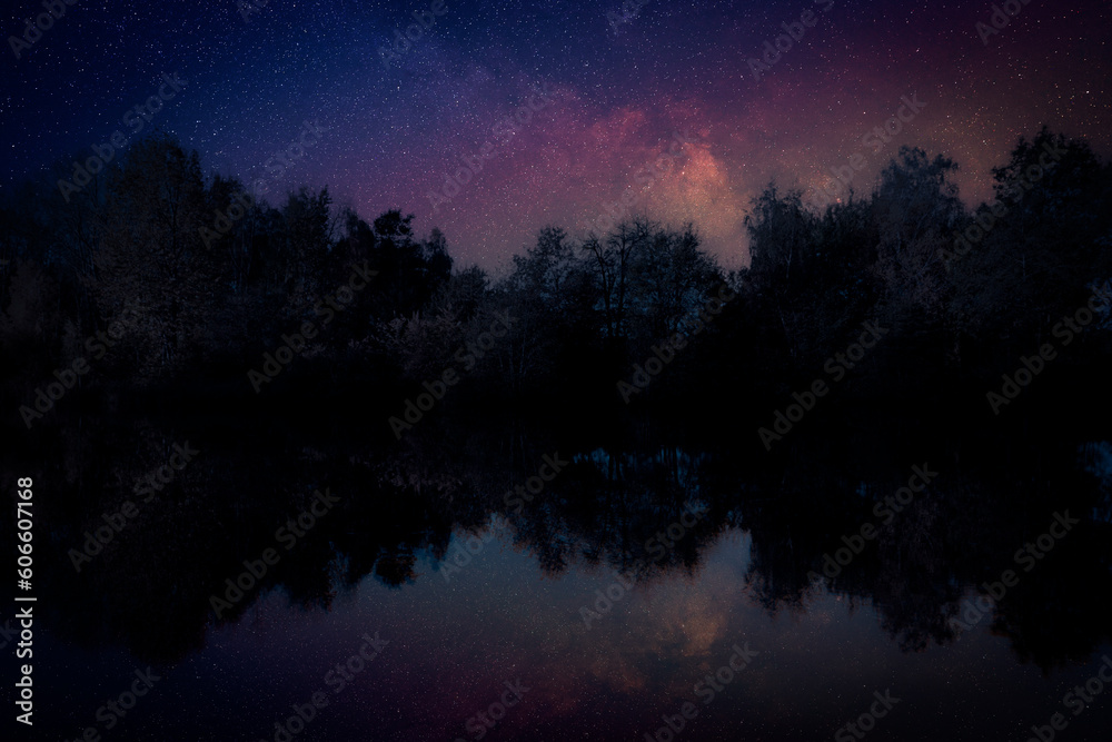 Amazing starry sky and trees reflecting in lake at night Amazing starry sky and trees reflecting in lake at night