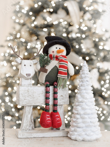 snowman sitting on reindeer with Christmas tree