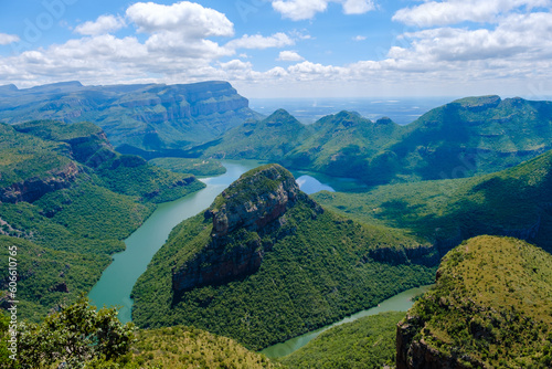 Panorama Route South Africa, Blyde river canyon with the three rondavels, view of three rondavels with a blue sky and green hills during summer