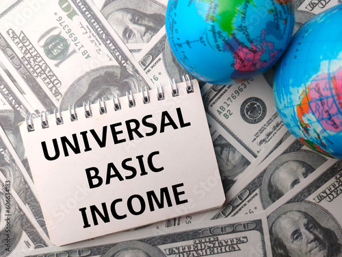 Obraz na plátně Earth globe and notebook with the word UNIVERSAL BASIC INCOME