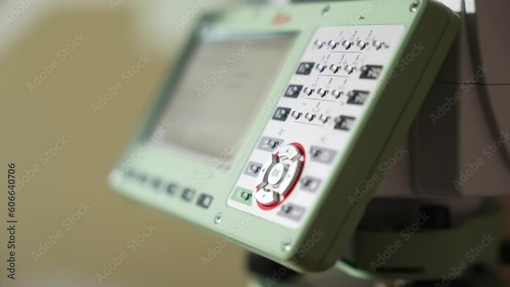 A man's hand presses buttons with a stylus on the control panel. Geodetic Tool Control Panel. A man's hand presses buttons with a stylus on the control panel. Geodetic Tool Control Panel.