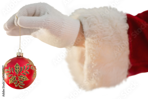 Digital png photo of santa claus hand holding christmas bauble on transparent background