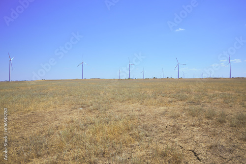 wind farm in the steppe against the blue sky