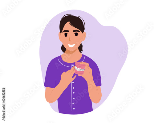 Dentist holds teeth with braces.
The concept of orthodontic alignment and braces, vector illustration
