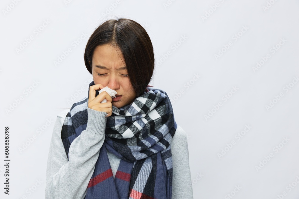 Asian woman cold flu holding handkerchief stuffed nose and coughing with fever sick from virus on white background, copy space Asian woman cold flu holding handkerchief stuffed nose and coughing with fever sick from virus on white background, copy space