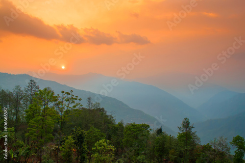 Beautiful sunrise in mountains of Himalayas, Hee Barmiok village of Sikkim, India. Great Himalayan mountain peaks in the background.