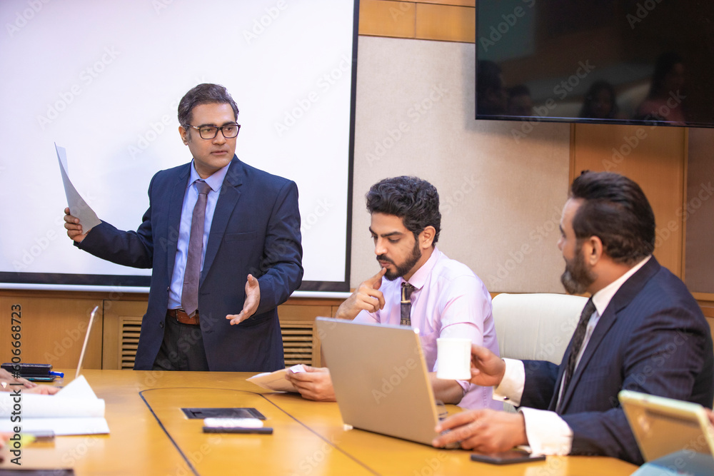 custom made wallpaper toronto digitalIndian businessman explaining project detail in a meeting to his partner or employee.
