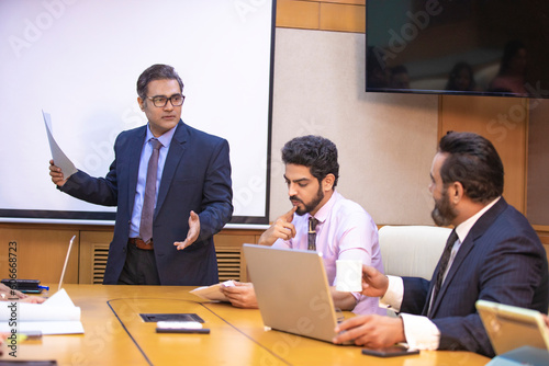 Wallpaper Mural Indian businessman explaining project detail in a meeting to his partner or employee. Torontodigital.ca