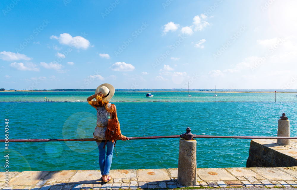 Woman standing looking at panoramic view of Altanic ocean coast and boats-  ( Le croisic)Pays de la Loire,  Loire Atlantic