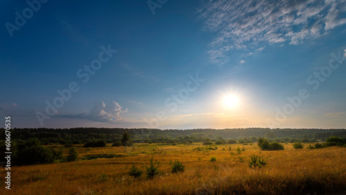 Natural summer sunrise. Beautiful sky. Countryside landscape. Under scenic colorful sky at sunrise.