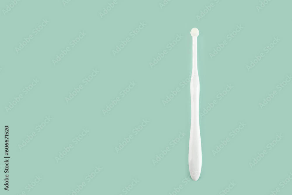 special toothbrush for cats and small dogs on a green background, copy space