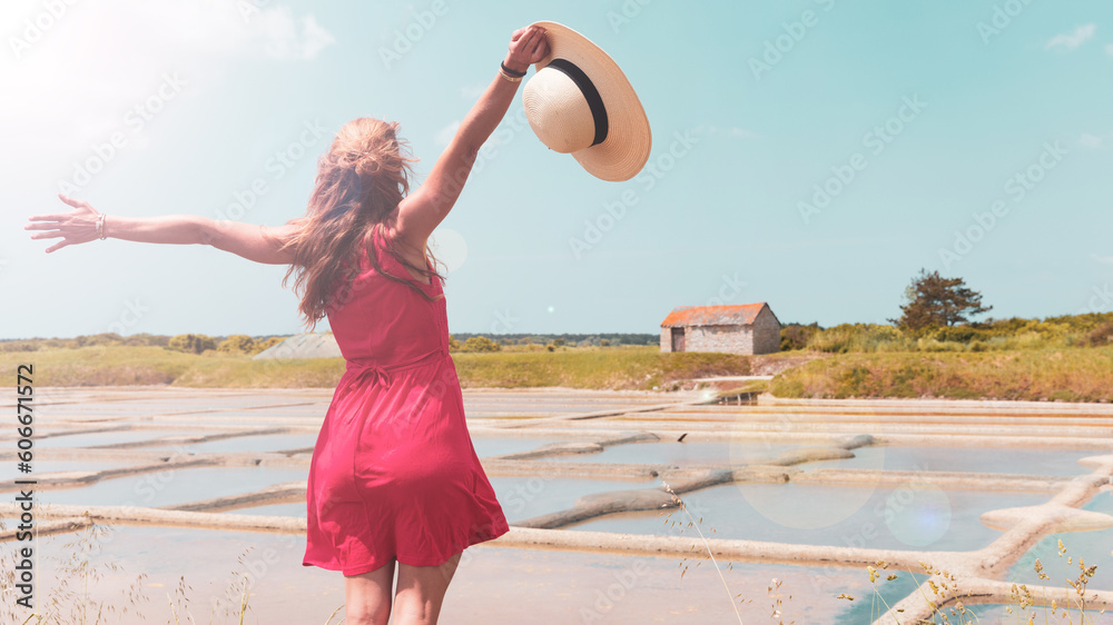 Αυτοκόλλητο Happy woman with red dress enjoying salt marsh in Guerande,  Saline- Loire Atlan