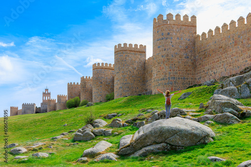 Impressive surrounding wall, Avila in Spain, Woman tourist