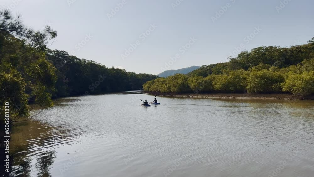 Landscape evening relaxing view of people relax paddle canoe or kayak in calm river on mangrove forests. Holiday travel activities concept. Landscape evening relaxing view of people relax paddle canoe or kayak in calm river on mangrove forests. Holiday travel activities concept.