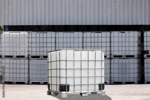 white IBC containers with the factory background. photo
