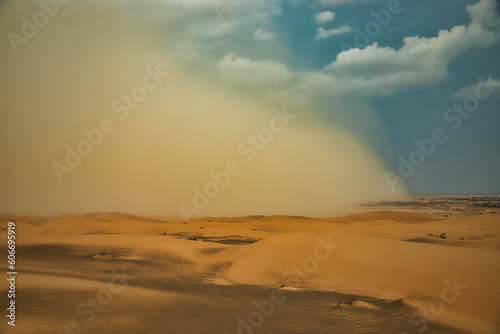 Starting sand storm in desert of high altiude with cumulonimbus rain louds.