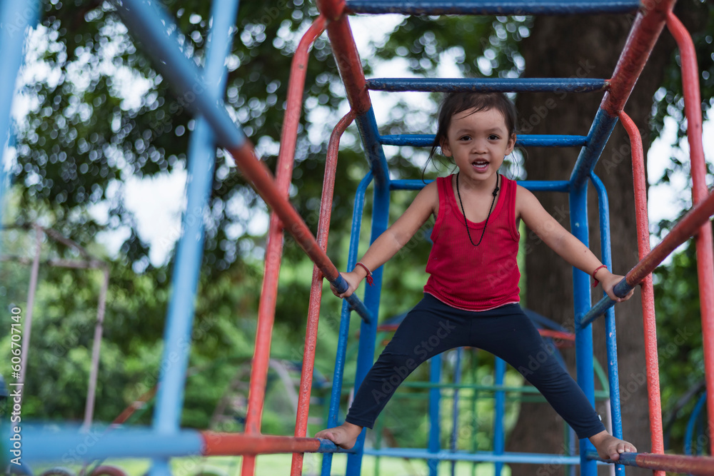 Fototapeta premium Kids playing on outdoor playground, kids playing in school or kindergarten, kids active on colorful slides and swings, healthy summer activities for kids.