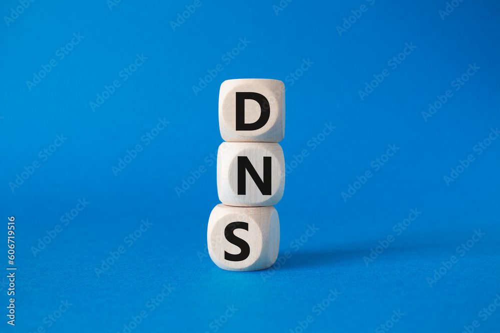 DNS -Domain Name Server - Consumer Price Index symbol. Concept word DNS on wooden cubes. Beautiful blue background. Business and DNS concept. Copy space. DNS -Domain Name Server - Consumer Price Index symbol. Concept word DNS on wooden cubes. Beautiful blue background. Business and DNS concept. Copy space.