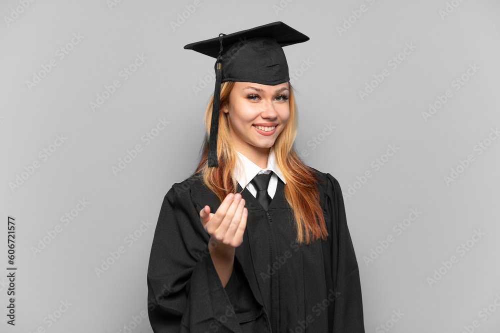 Young university graduate girl over isolated background inviting to come with hand. Happy that you came Young university graduate girl over isolated background inviting to come with hand. Happy that you came