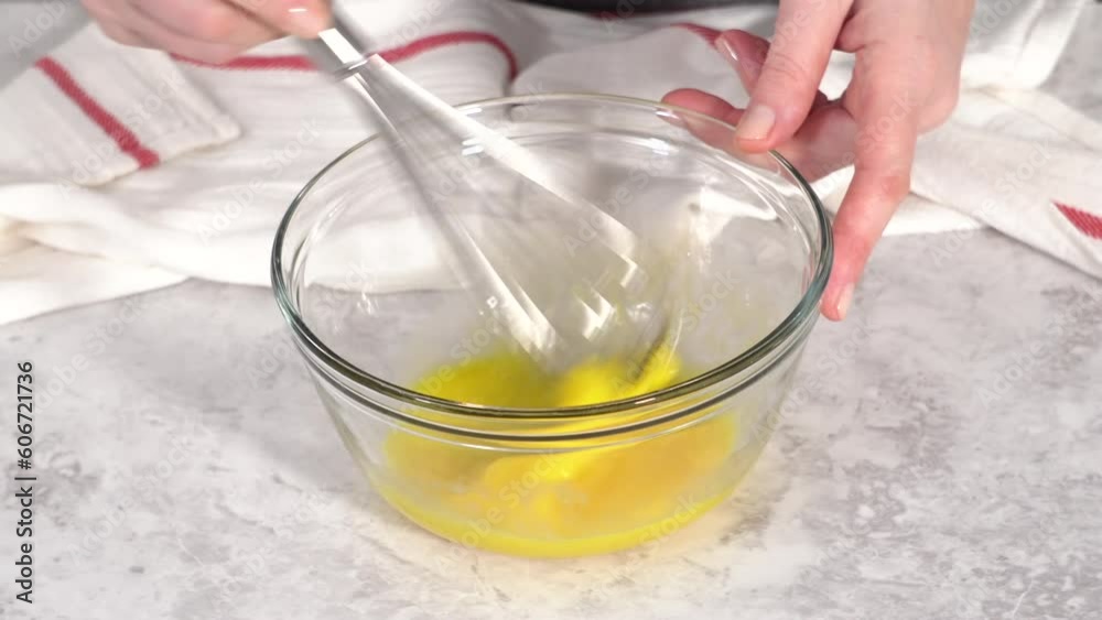 Time lapse. Step by step. Mixing ingredients in a glass mixing bowl to prepare chocolate mug cakes. Time lapse. Step by step. Mixing ingredients in a glass mixing bowl to prepare chocolate mug cakes.