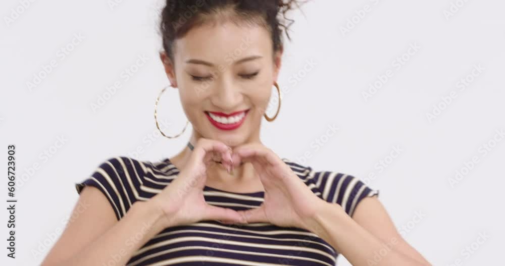 Fashionable young Chinese woman doing heart shape gesture,4K Fashionable young Chinese woman doing heart shape gesture,4K