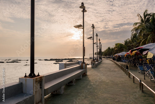 Chon buri Thailand, 24 Dec 2021, Front view of the view Bangsaen Beach blue sky palm tree whit Atmosphere. Tourists people enjoy trip travel are relaxing at the beach during sunset summer in vacation. photo