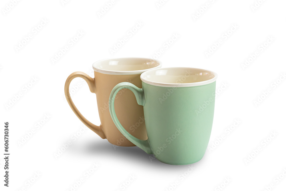 View of two empty ceramic coffee mugs brown and green isolated on white background with clipping path. View of two empty ceramic coffee mugs brown and green isolated on white background with clipping path.