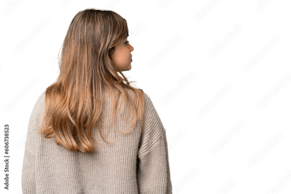 Young girl over isolated chroma key background in back position and looking side Young girl over isolated chroma key background in back position and looking side
