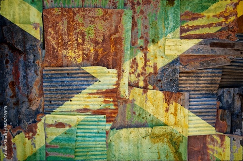 Flag of Jamaica on rusty corrugated iron sheets forming a wall or a fence