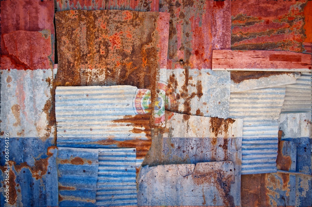 Naklejka premium Shot of the flag of Palraguay painted on rusty overlapping corrugated iron sheets