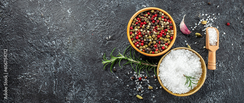 peppercorns and sea salt on a dark background, Long banner format. top view
