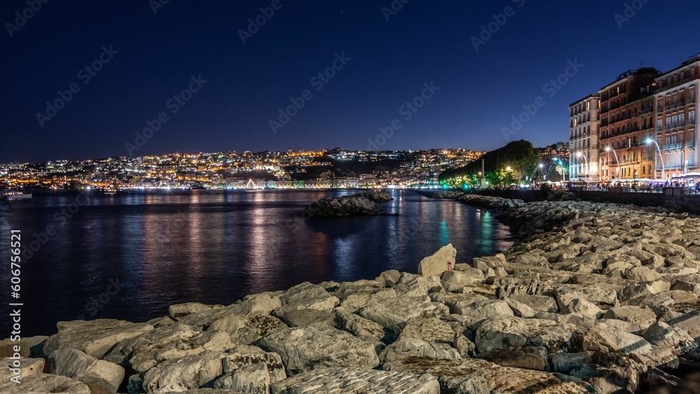 Beautiful night view of sandy beach and illuminated houses by the sea in  Amalfi Coast, Italy