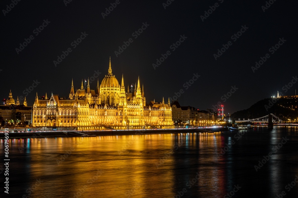 View of the illuminated Hungarian Parliament Building at the night reflected in waters in Budapest