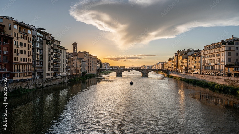 Beautiful view of a bridge over a river during a sunset in Florence, Tuscany, Italy