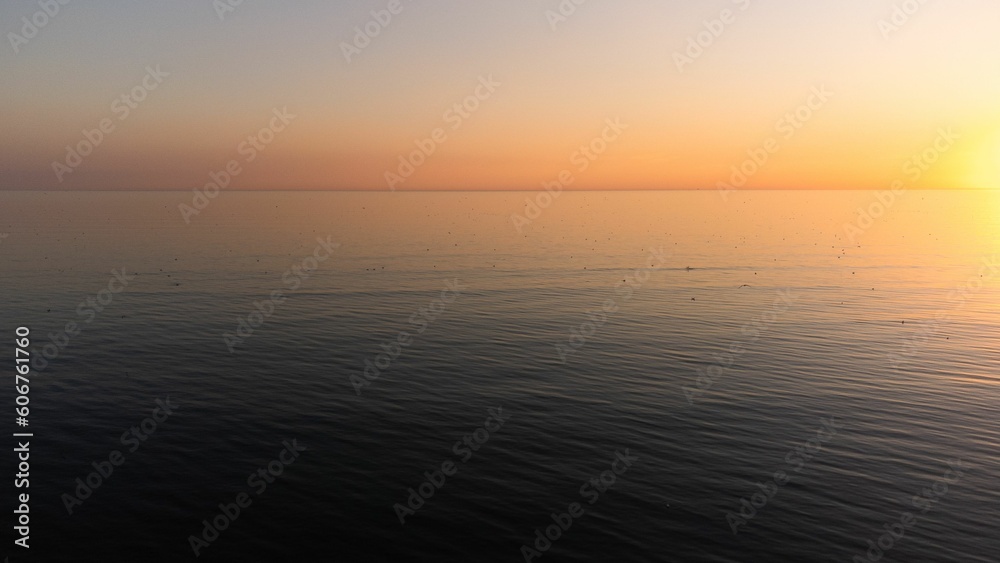 Scenic view of a tranquil sea water under colorful dusk sky at sunset in Denmark