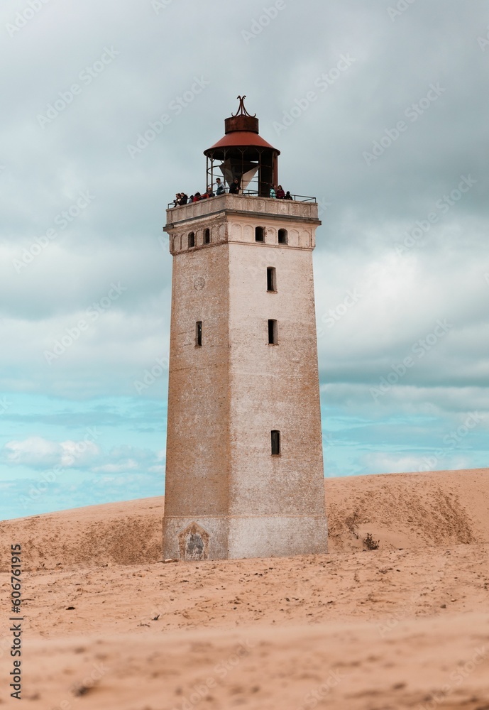 Vertical shot of the Rubjerg Knude lighthouse on sand dunes in Lokken, Denmark