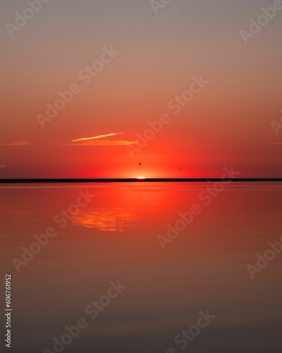 Fototapeta Naklejka Na Ścianę i Meble -  Mesmerizing seascape with sunset in a red sky