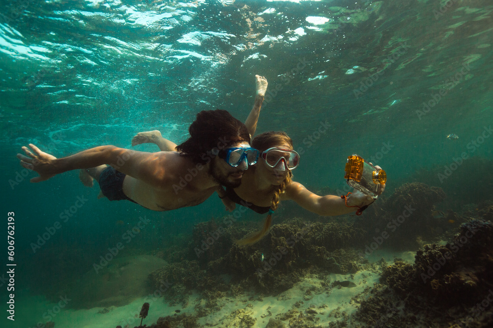 Couple is making photo underwater