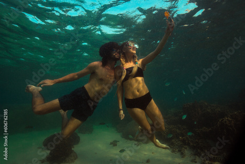 The girl is making photo underwater