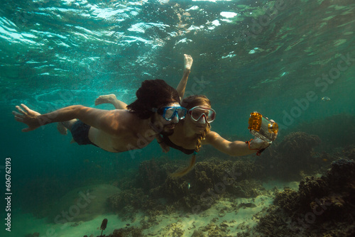 Couple is making photo underwater