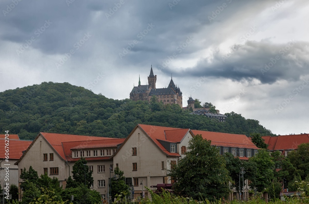 Antique castle Wernigerode in Germany surrounded by mountains covered by trees Antique castle Wernigerode in Germany surrounded by mountains covered by trees