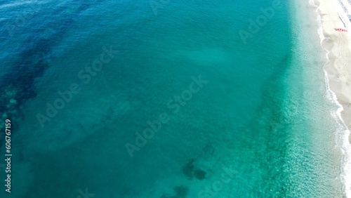 Aerial drone shot of a blue sea in Monterosso al Mare in the province of La Spezia, Italy