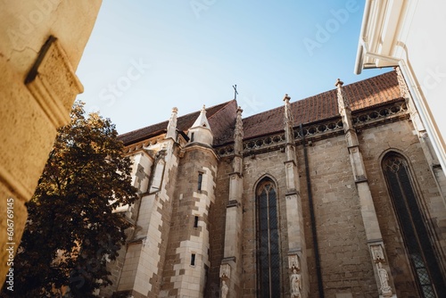 Low angle of The Black Church (Biserica Neagra) in Brasov, Romania with blue sky photo