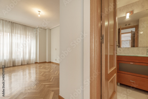 An empty room with a varnished oak parquet floor