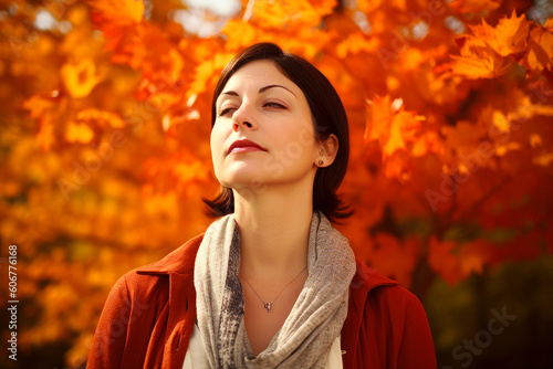 Portrait of a beautiful young woman on a background of autumn leaves