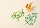 The Thank you text with butterfly paper carve on pastel background.