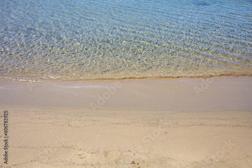 Sandy empty beach  ocean Aegean sea water close up. Greece summer vacation  Cyclades island. Space